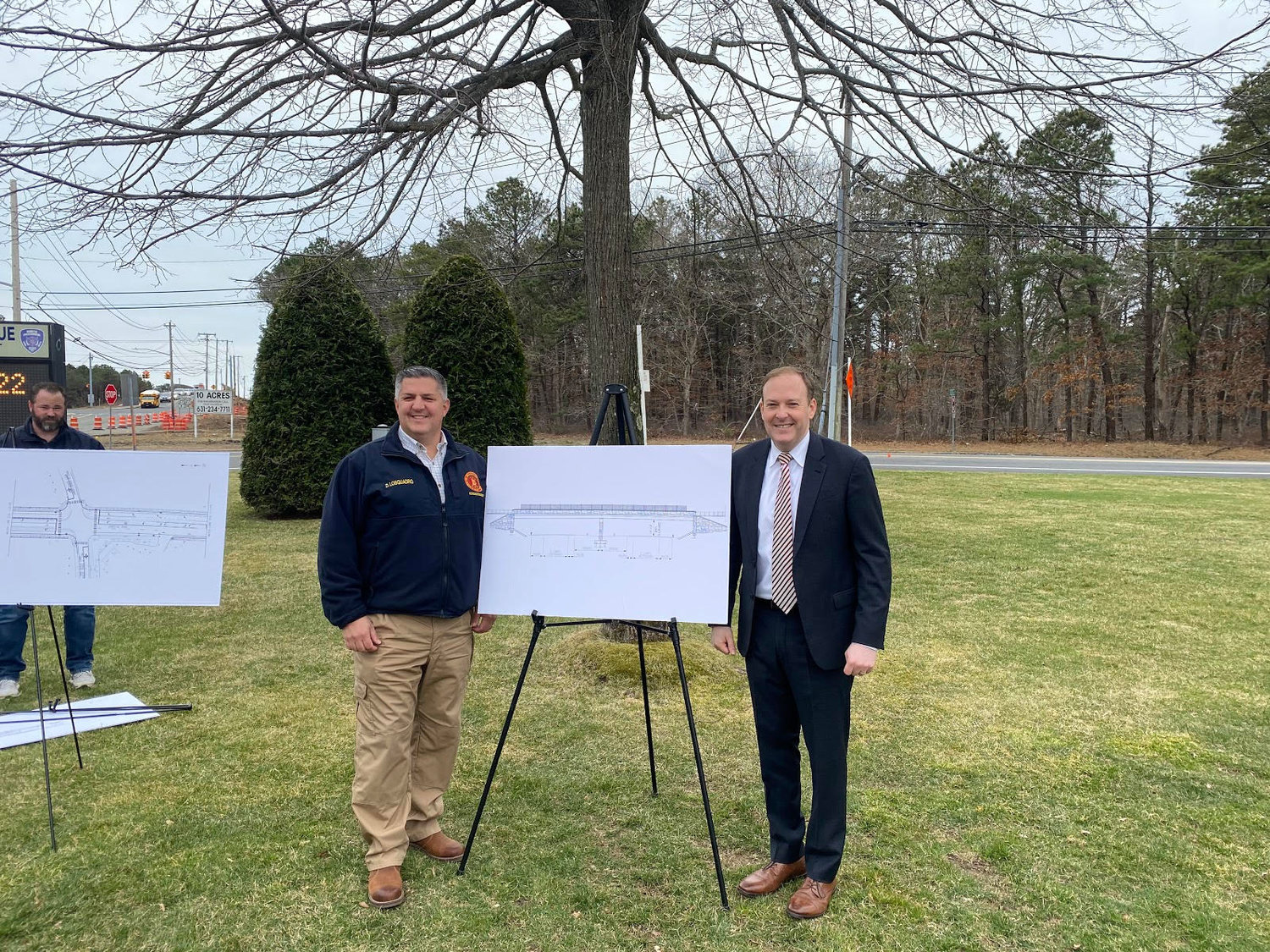 Highway superintendent Dan Losquadro and congressman Lee Zeldin stand with a rendering of the new Hospital Road Bridge.